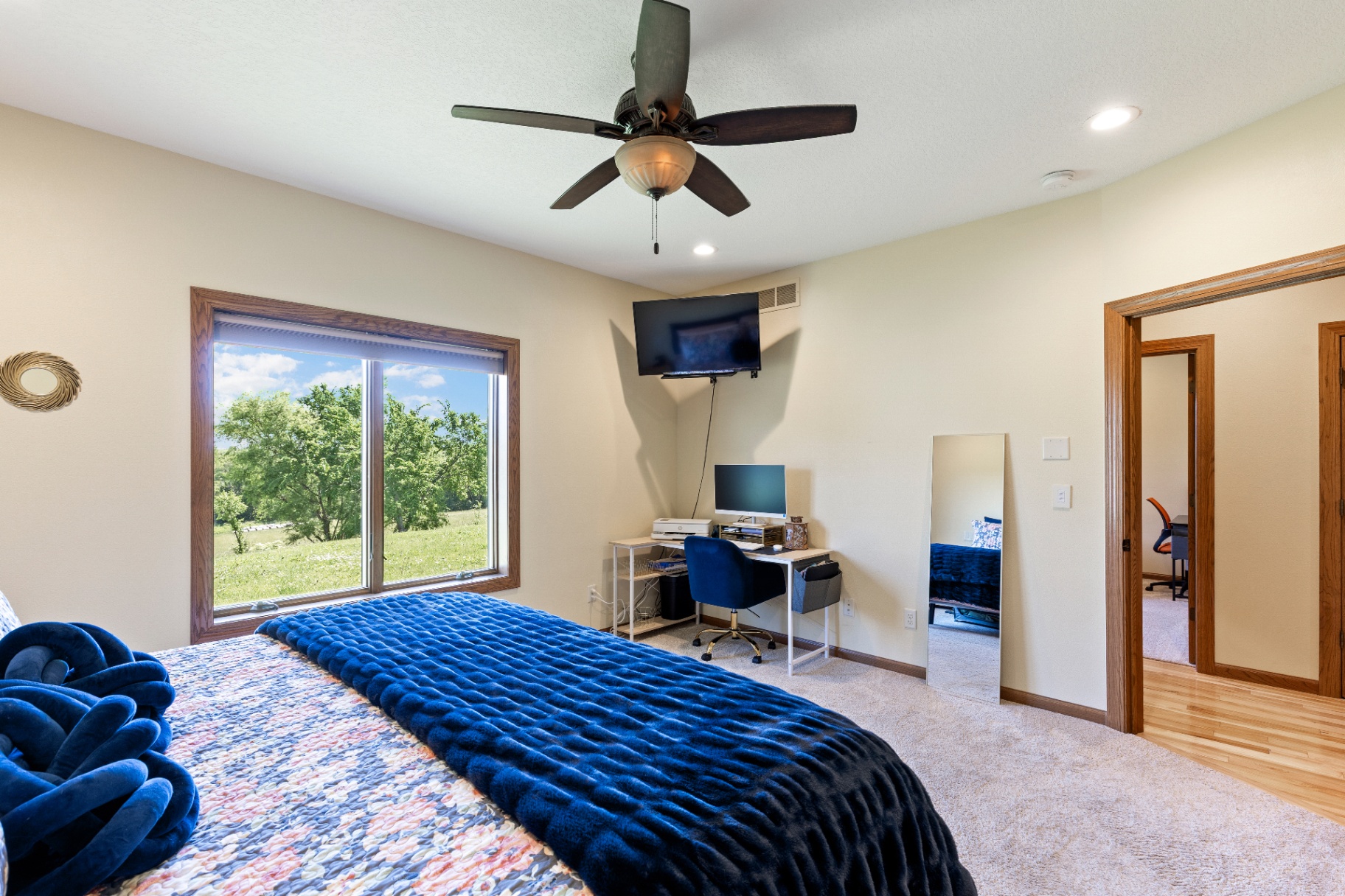 Primary bedroom with wide outdoor view and corner workspace