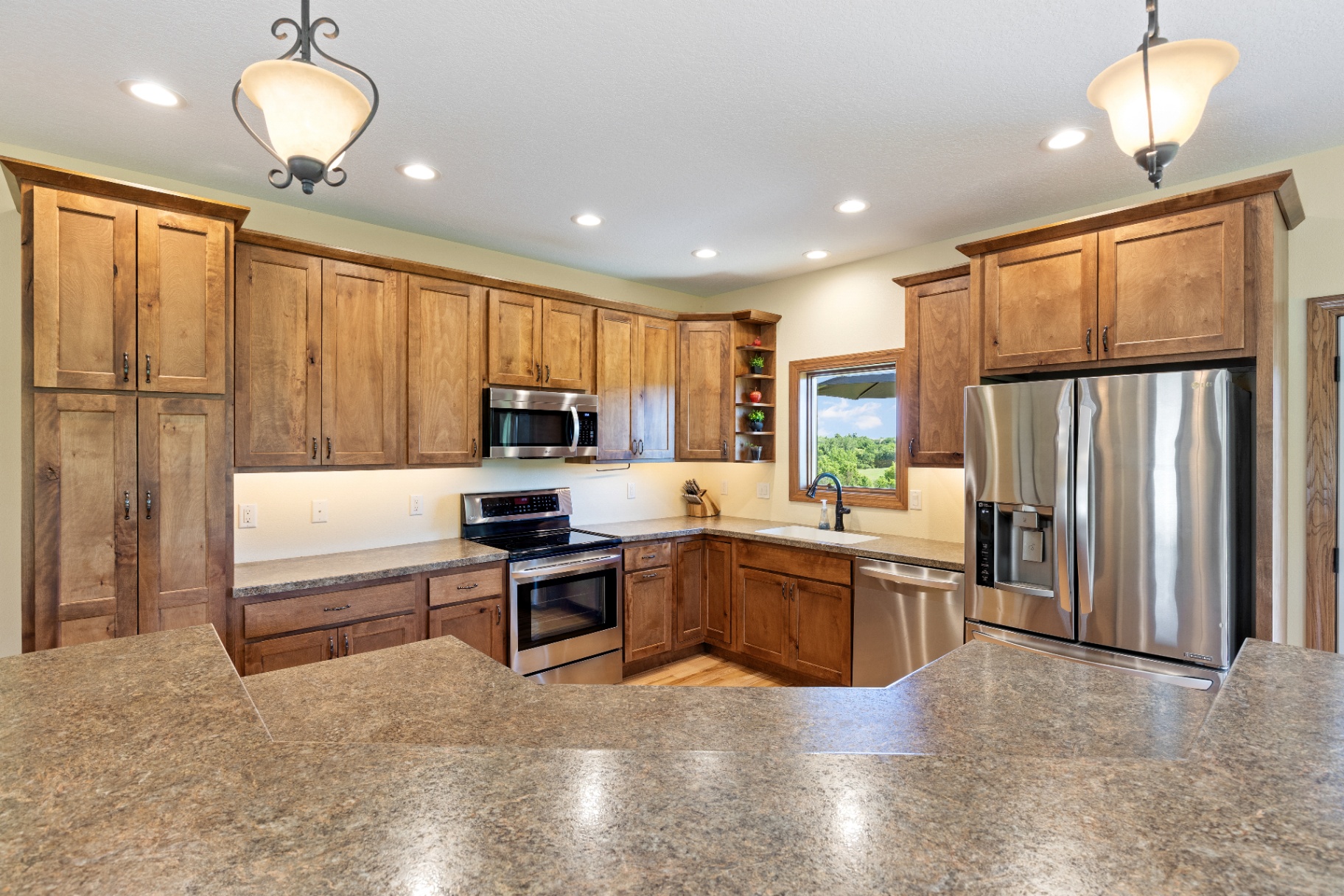 Detailed view of kitchen cabinets, range, and refrigerator