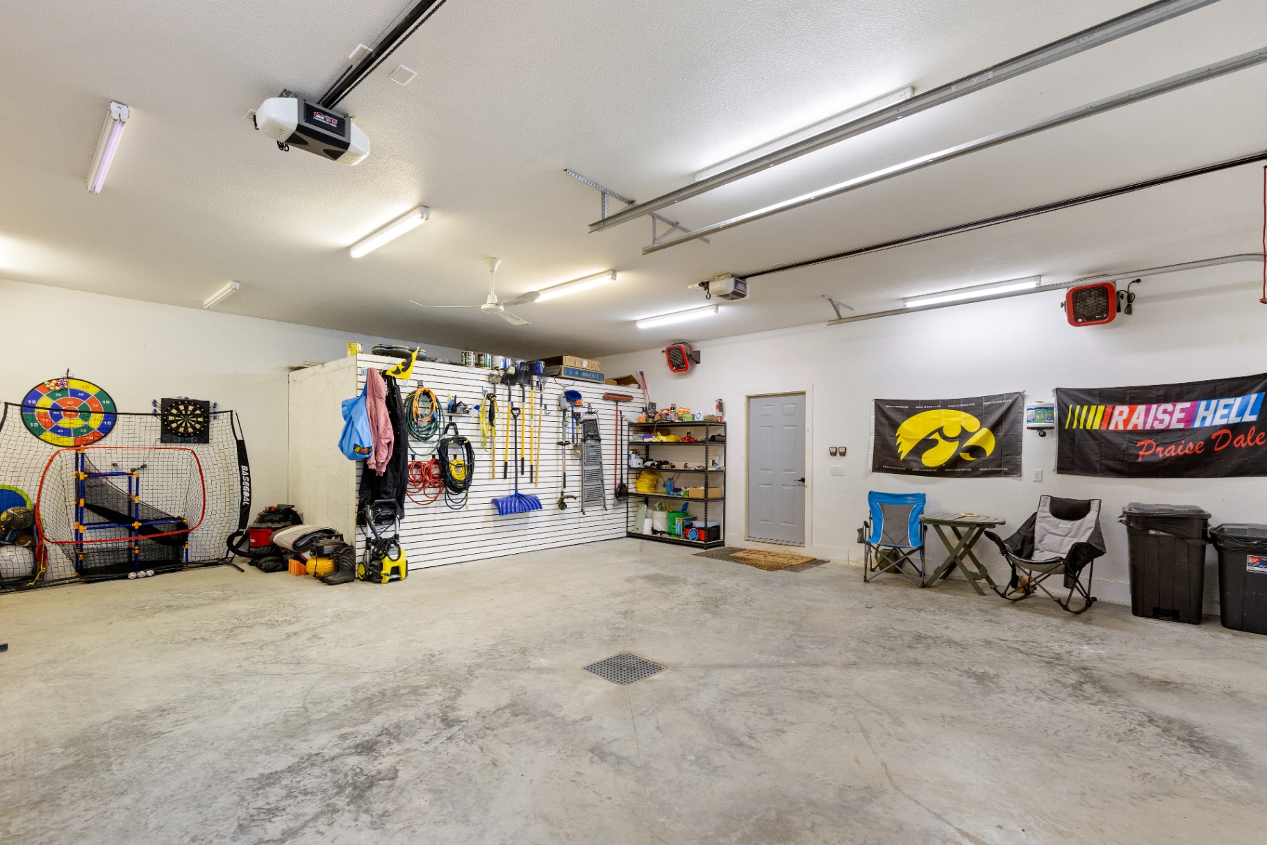 Garage interior with sports setup, shelving, and utility space
