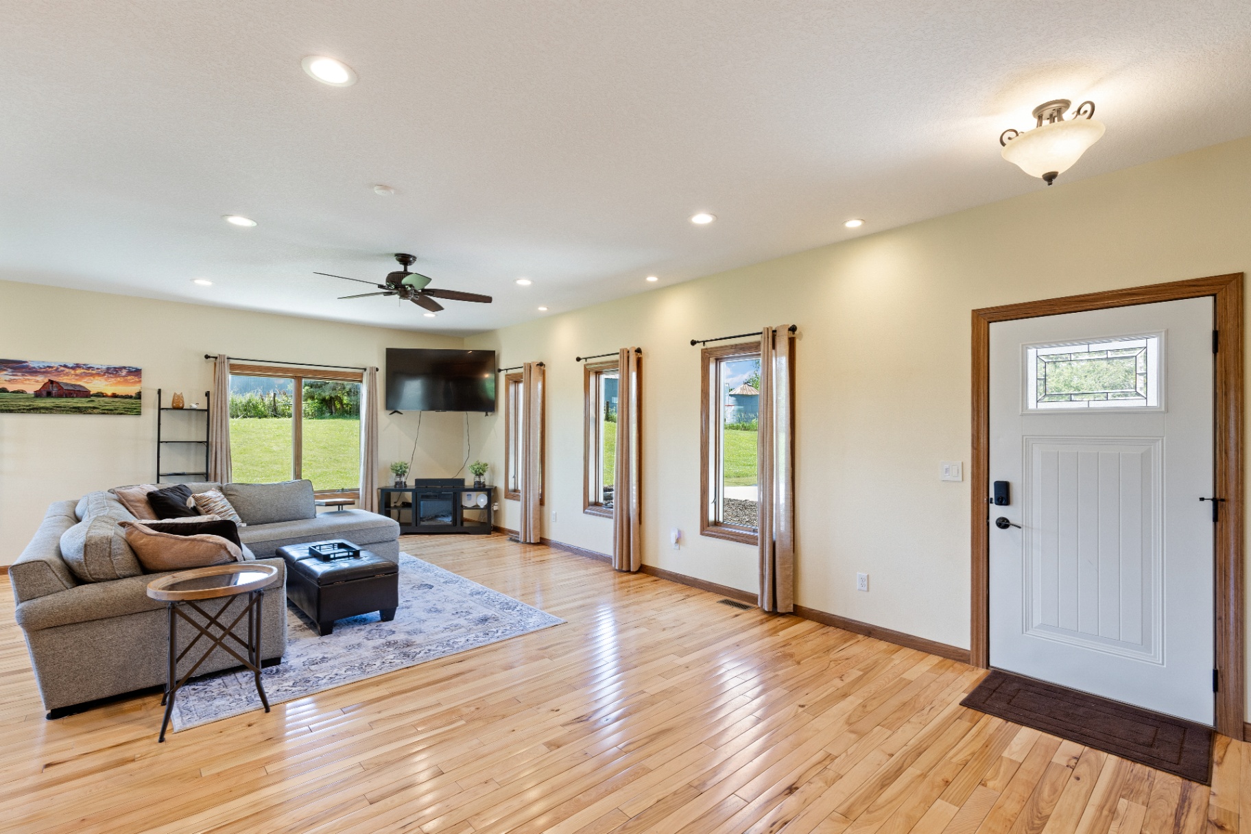 Living room with front entry and large windows