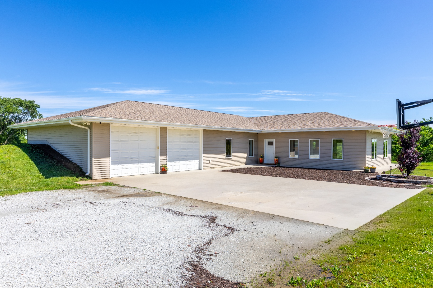 Front exterior of the ranch with three-car garage