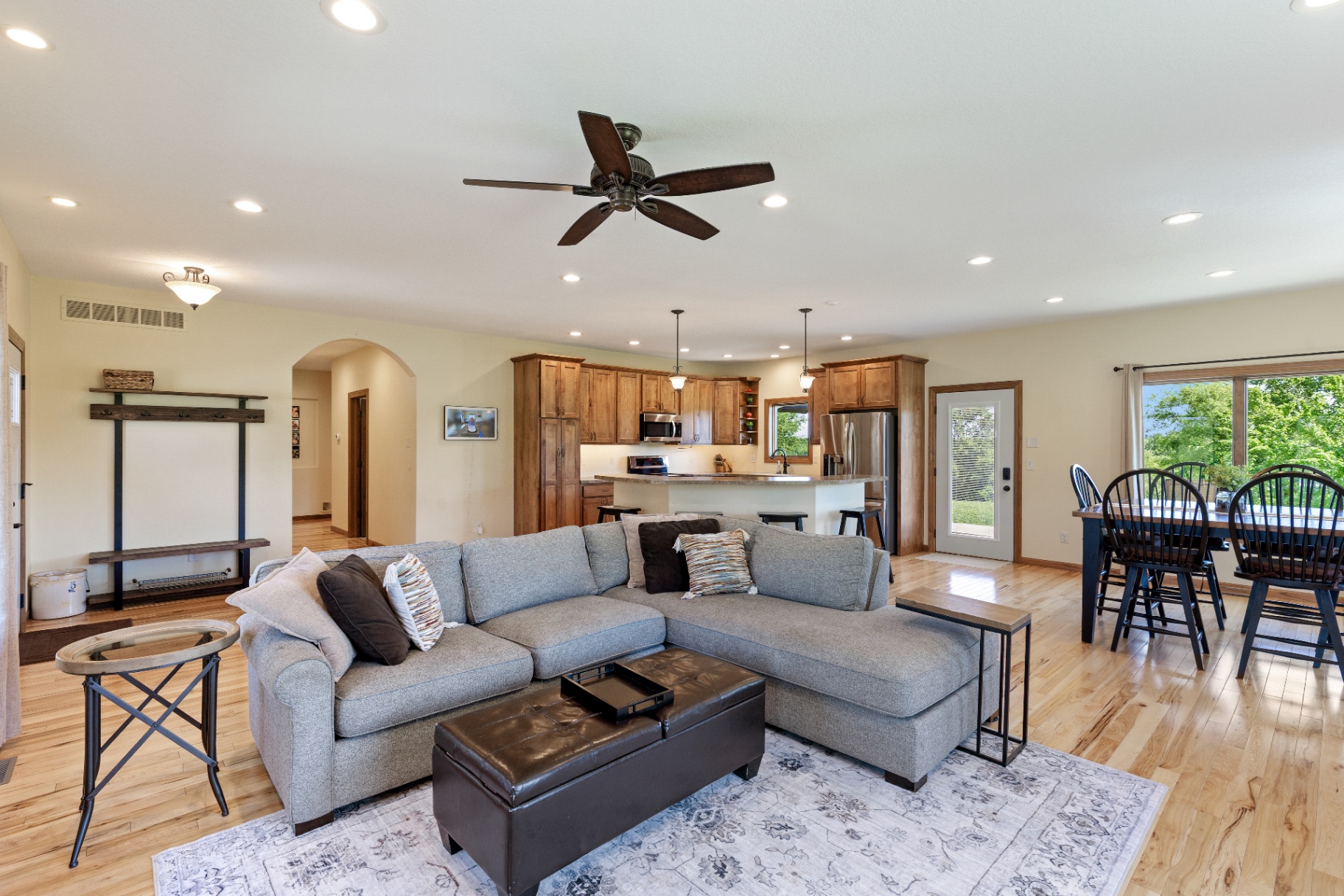 Sectional seating area with kitchen and dining behind