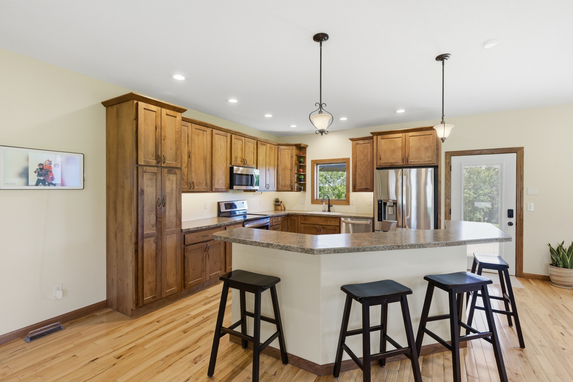 Kitchen peninsula and wood cabinetry