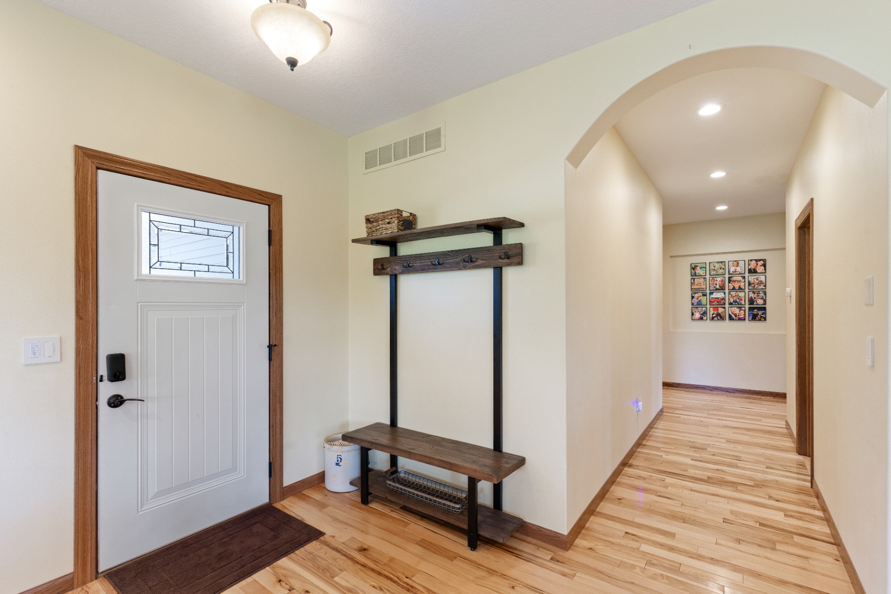 Entryway with arched hallway and built-in bench