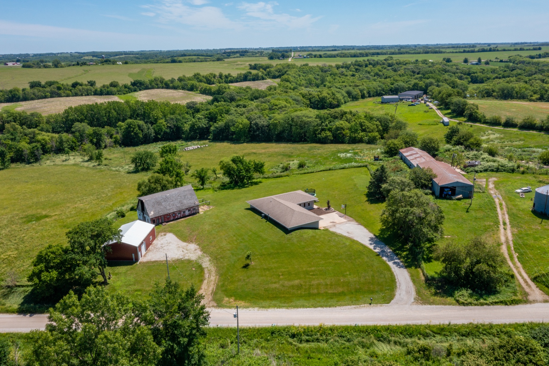 Aerial view showing the property layout and neighboring farmland
