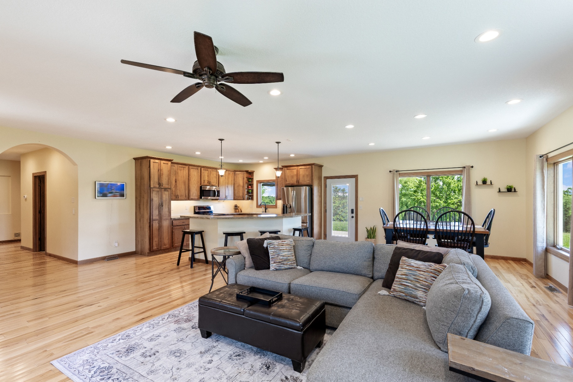 Wide view from the living room across the kitchen and dining area
