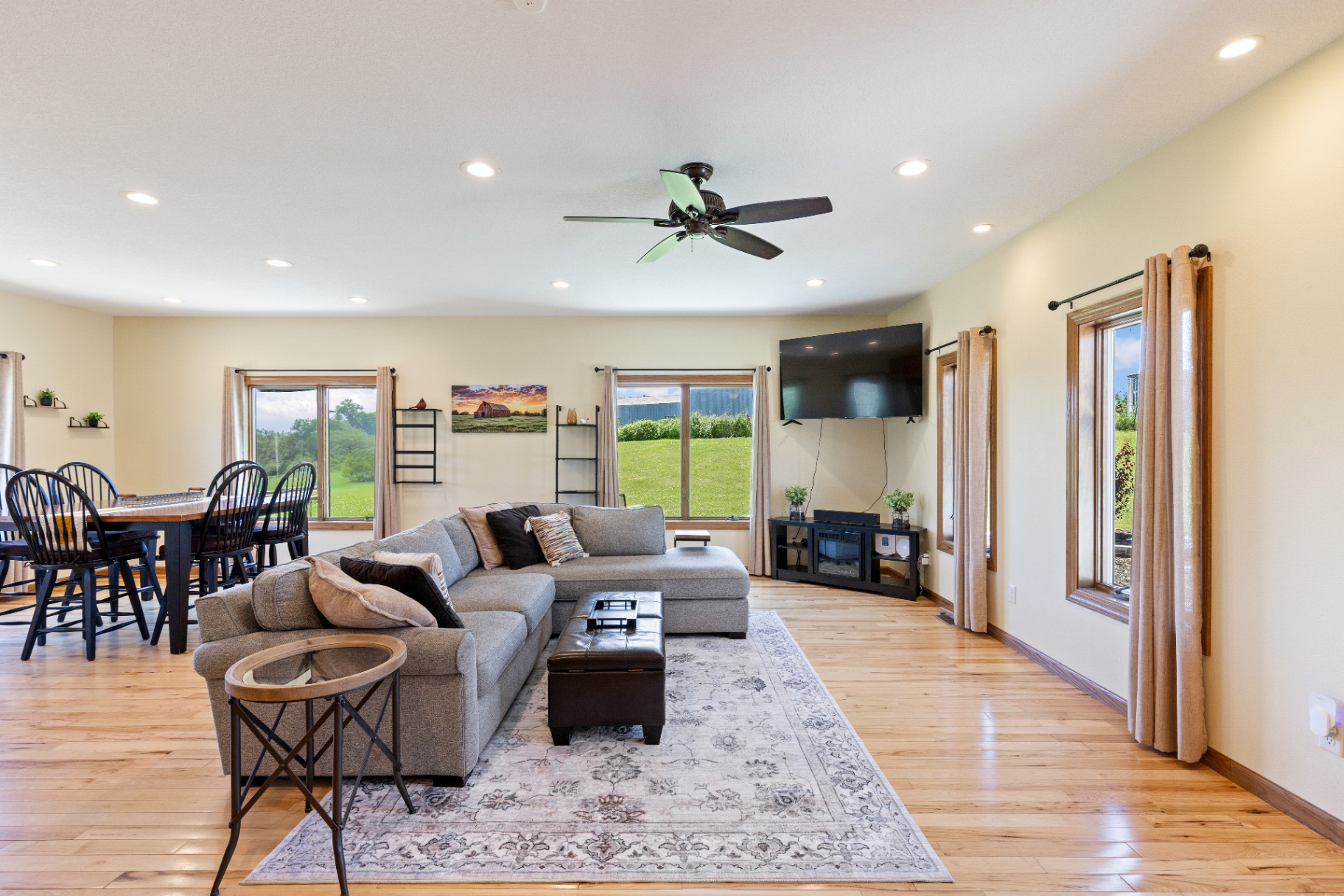 Living room with dining area to the left and pasture views