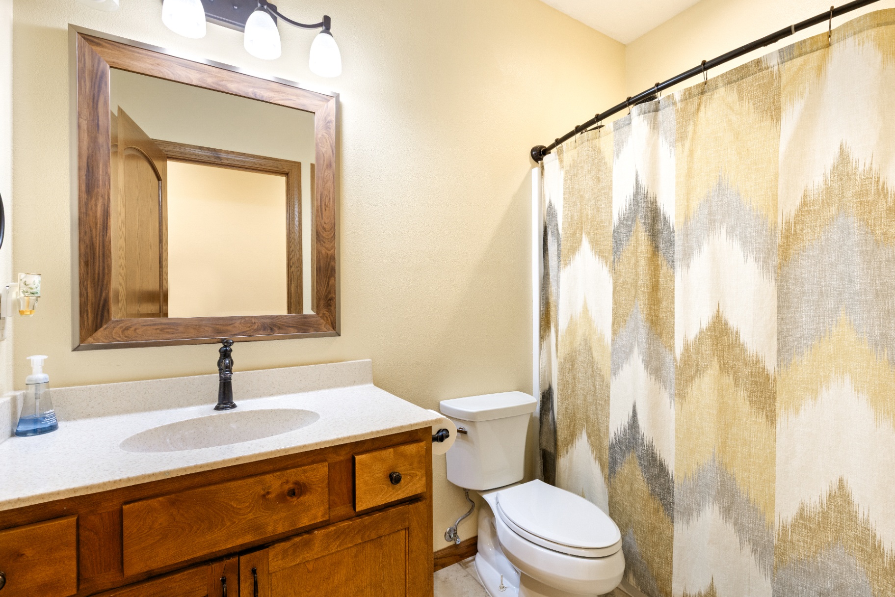 Full guest bathroom with vanity and tub-shower