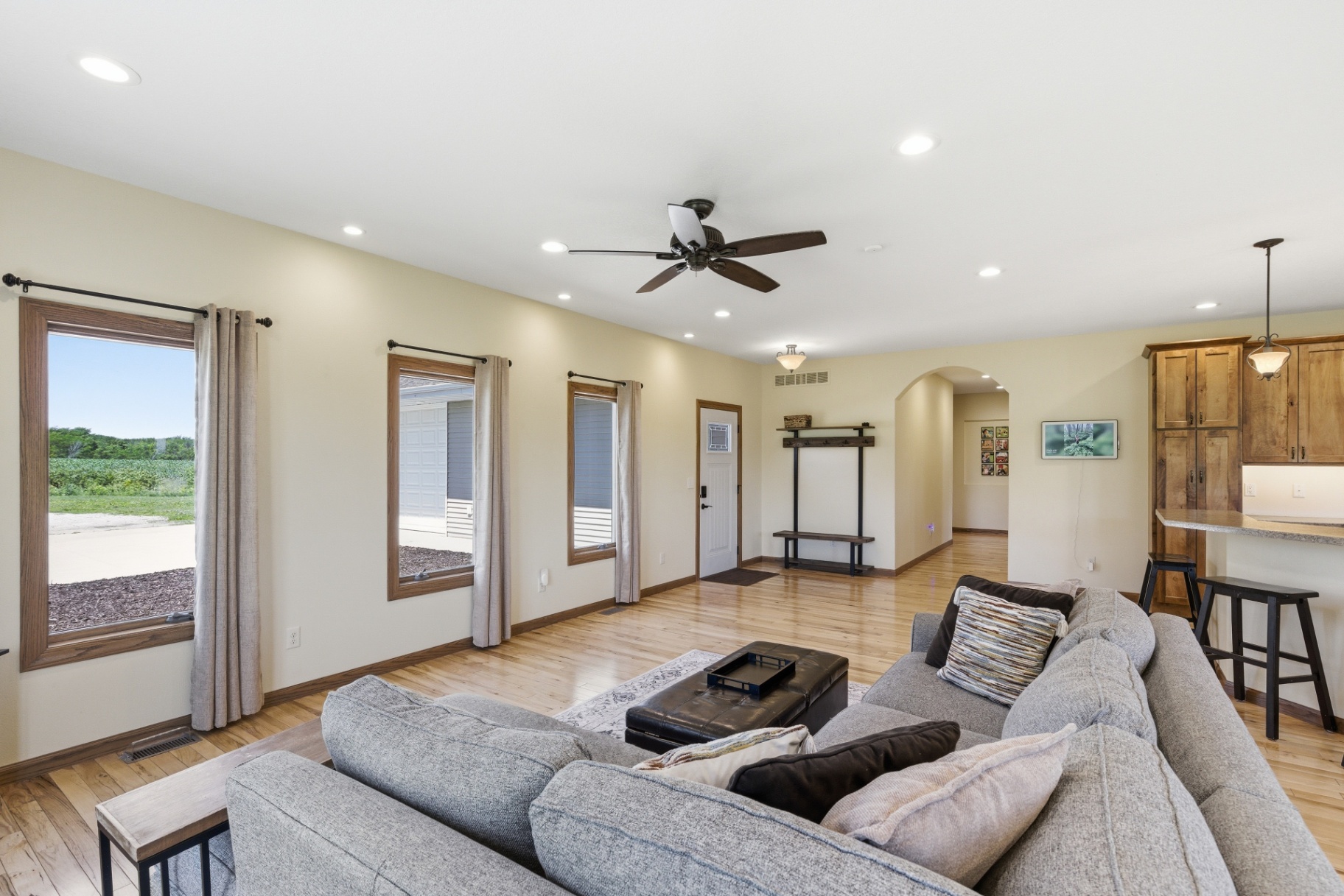 Open living room with hallway and kitchen bar seating