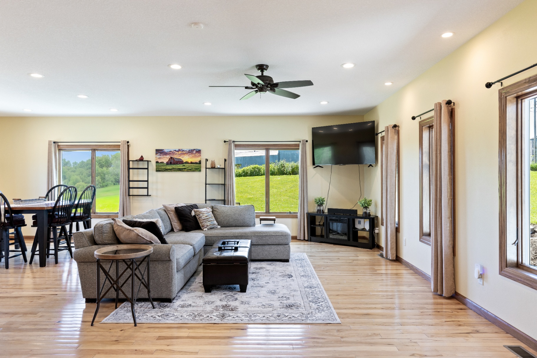 Living room with mounted TV and dining beyond