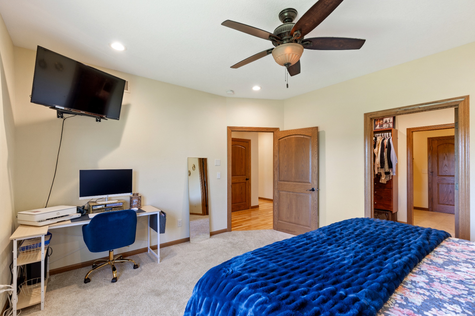 Primary bedroom showing workspace and walk-in closet entry