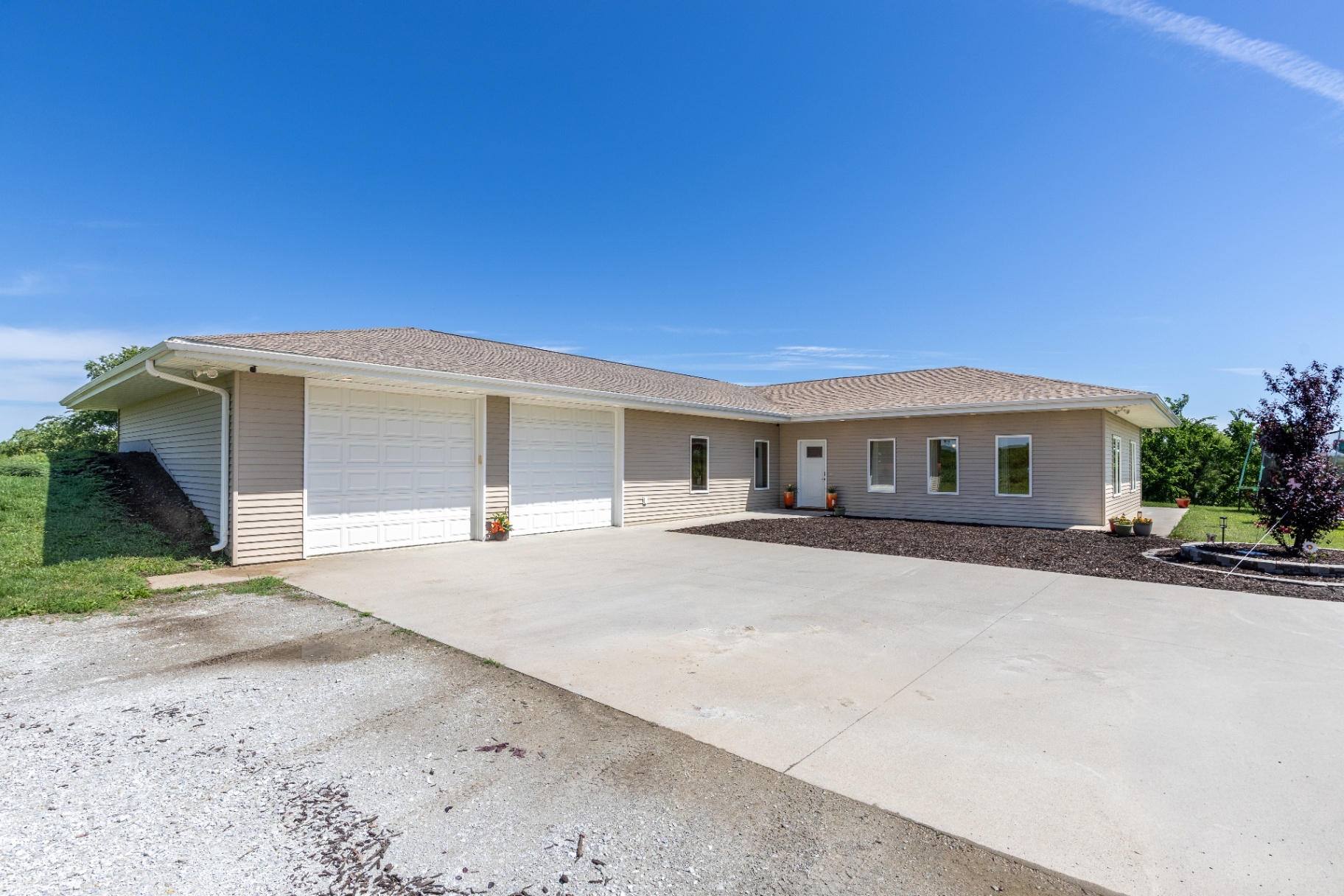 Wide concrete drive leading to the garage