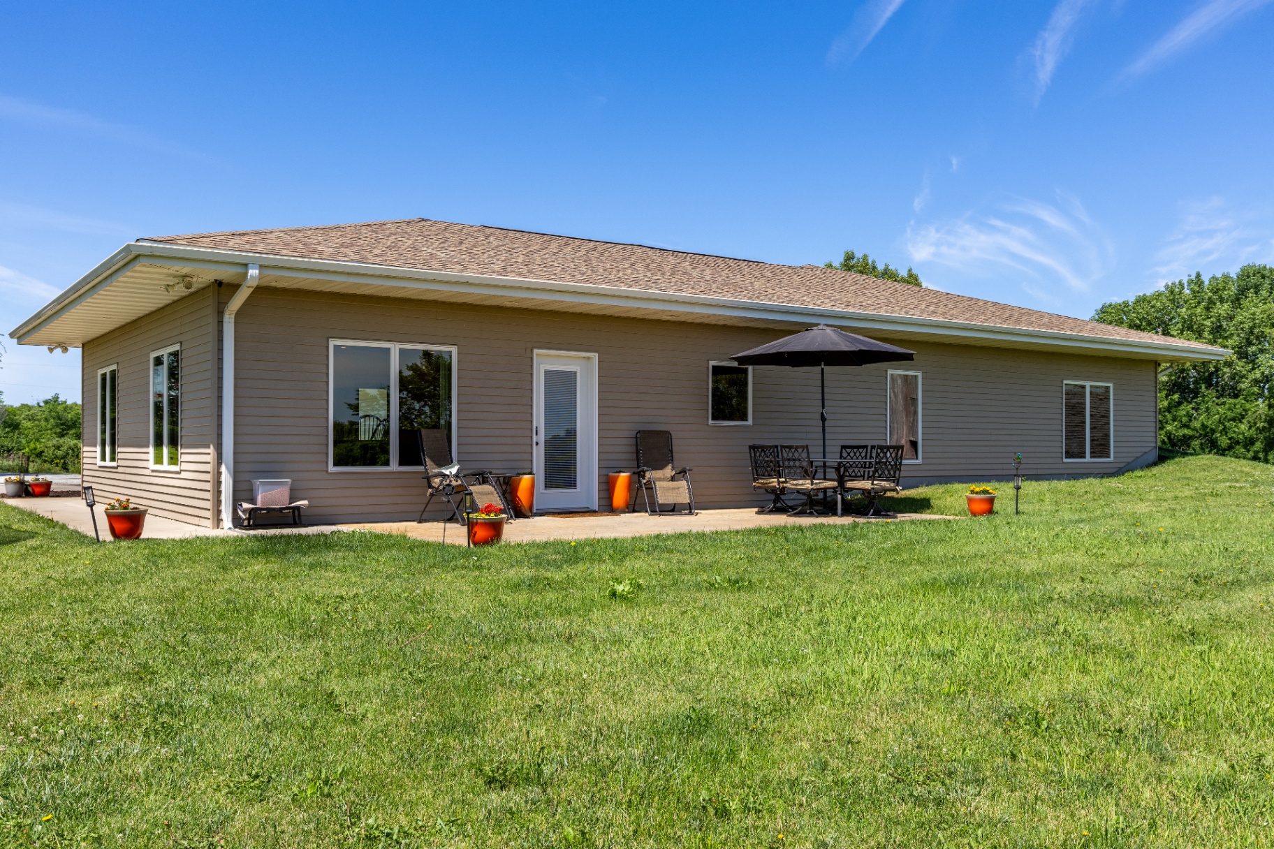 Back patio exterior with lawn and blue sky overhead